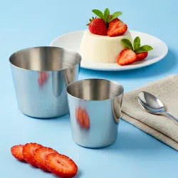 Dariole and pudding molds with dessert presentation and strawberries