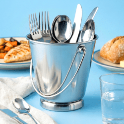 a kh cutlery holder on a blue background with food in the background